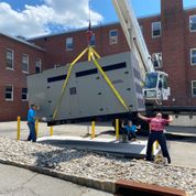 grey generator being lifted